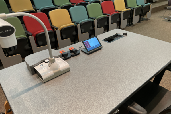 Pedestal - instructor view of the pedestal at the front of the room. Microphones on surface.