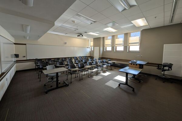 Back of room view of student tablet arm seating and markerboard at rear of room