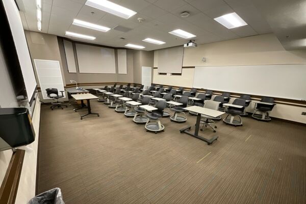 Back of room view of student tablet arm seating and markerboard on rear wall