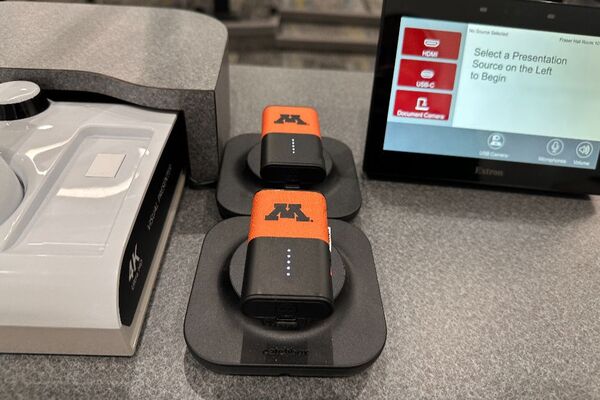 Pedestal - surface view of two wireless mics in charging base	