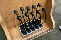 Pedestal - view of assistive listening devices in charging base