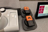 Pedestal - surface view of two wireless mics in charging base