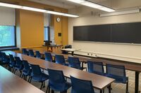 Front of room view with lectern on left in front of chalkboard