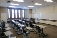 Front of room view with lectern on left in front of markerboard 