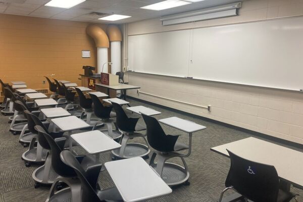 Front of room view with lectern on left in front of markerboard 