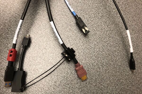 Pedestal - laptop cable connections with cables pulled out showing cable ends