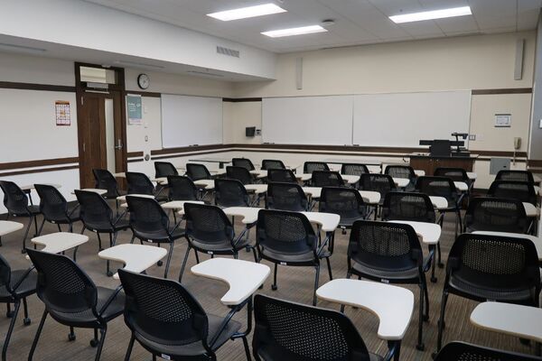 Front of room view with lectern on right in front of markerboard 