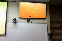 Monitor mounted so that students will be able to see remote participants without having to turn to look at the projection screen