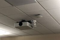 Camera mounted to ceiling and instructor enabled adjustments to the lens to allow the instructor to be "seen" by the camera in more locations around the room