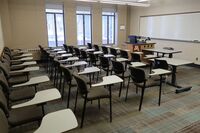 Front of room view with lectern on left in front of markerboard 