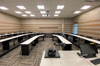 Back of room view of student tiered fixed-table and chair seating 