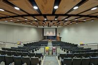 Front of room view with lectern center in front and projection screen lowered