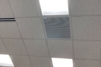 White 2¿ x 2¿ tile mounted in the ceiling to provide microphone coverage over student seating