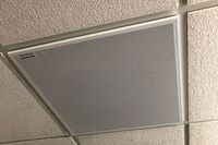 White 2¿ x 2¿ tile mounted in the ceiling to provide microphone coverage over student seating