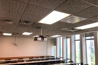 White 2¿ x 2¿ tile mounted in the ceiling to provide microphone coverage over student seating