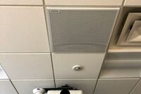 White 2¿ x 2¿ tile mounted in the ceiling to provide microphone coverage over student seating