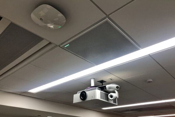 White 2¿ x 2¿ tile mounted in the ceiling to provide microphone coverage over student seating