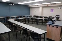 Back of room view of student tiered fixed table and chair seating 