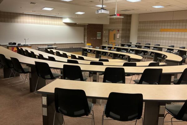 Front of room view with lectern on left in front of markerboard 