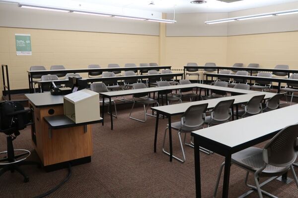 Back of room view of student tiered fixed table and chair seating