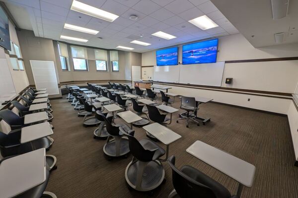 Front of room view with lectern on left in front of markerboard 