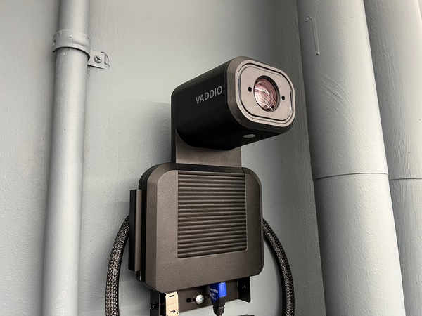 Camera mounted to a wall and instructor enabled adjustments to the lens to allow the instructor to be "seen" by the camera in more locations around the room