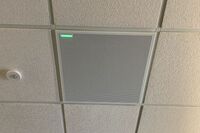 White 2¿ x 2¿ tile mounted in the ceiling to provide microphone coverage over student seating