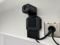 Camera mounted to a wall and instructor enabled adjustments to the lens to allow the instructor to be "seen" by the camera in more locations around the room