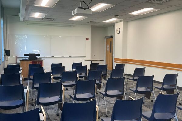 Front of room view with lectern on left in front of markerboard 