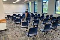 Front of room view with lectern on right in front of markerboard 