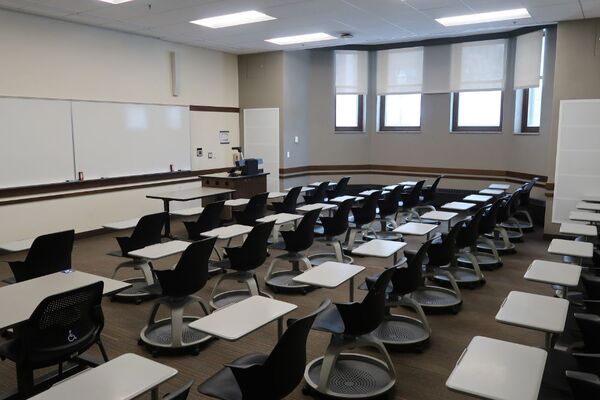 Front of room view with lectern on right in front of markerboard 