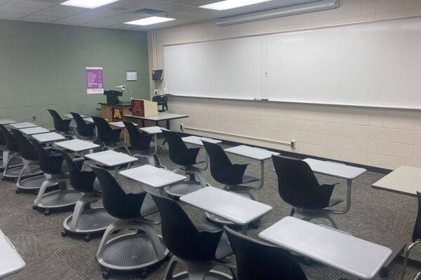 Front of room view with lectern on left in front of markerboard 