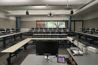 Back of room view of student tiered fixed table and chair seating