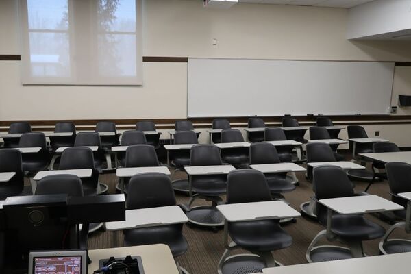 Back of room view of student tablet arm seating and markerboard on rear wall