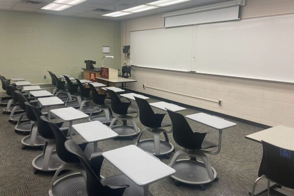 Front of room view with lectern on left in front of markerboard 