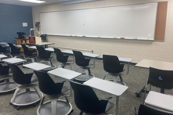 Front of room view with lectern on left in front of markerboard 