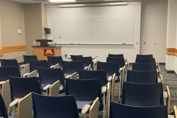 Front of room view with lectern on left in front of markerboard 