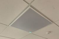 White 2¿ x 2¿ tile mounted in the ceiling to provide microphone coverage over student seating