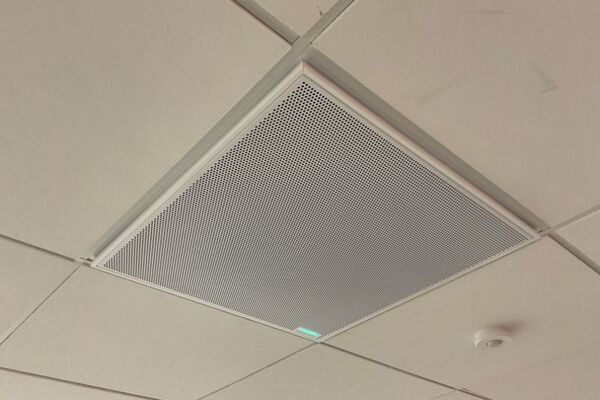 White 2¿ x 2¿ tile mounted in the ceiling to provide microphone coverage over student seating