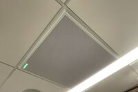 White 2¿ x 2¿ tile mounted in the ceiling to provide microphone coverage over student seating