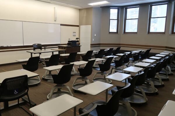 Front of room view with lectern on right in front of markerboard 