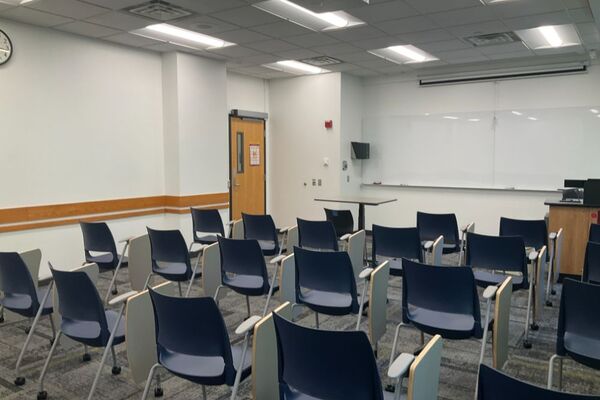 Front of room view with lectern on right in front of markerboard 