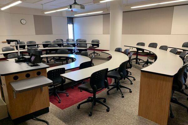 Back of room view of student tiered fixed-table and chair seating 