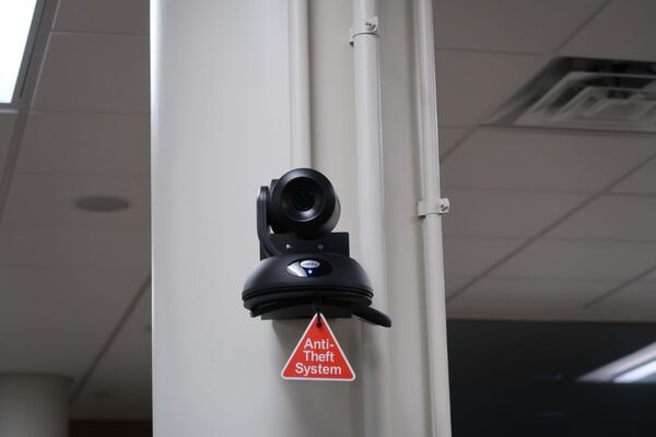 Camera mounted to a wall and instructor enabled adjustments to the lens to allow the instructor to be "seen" by the camera in more locations around the room