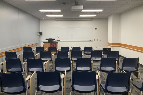 Front of room view with lectern on left in front of markerboard 