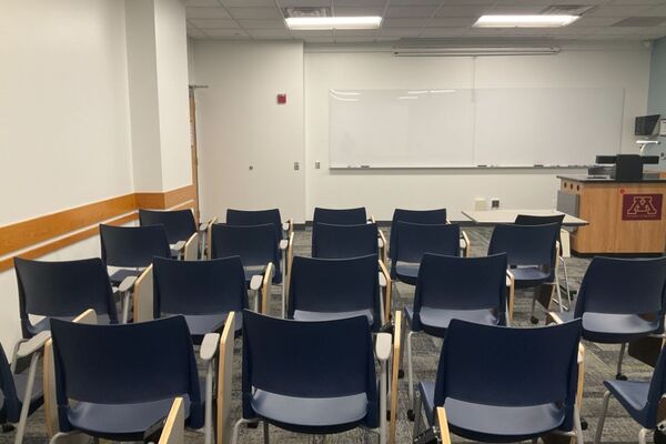 Front of room view with lectern on right in front of markerboard 