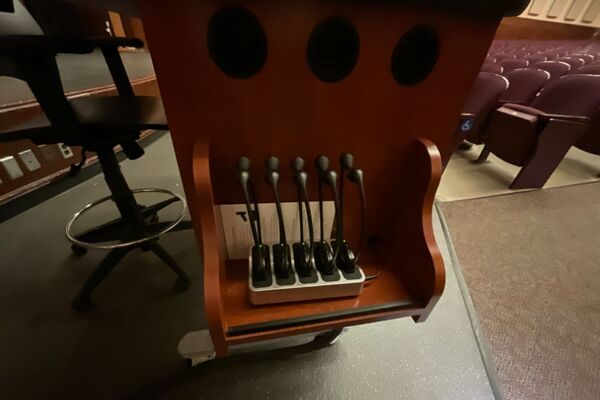 Assisted listening devices on pedestal shelf