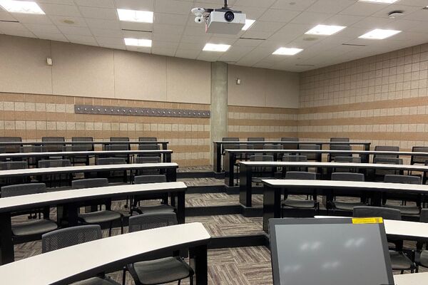 Back of room view of student tiered fixed-table and chair seating 