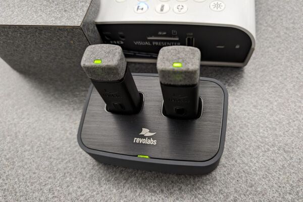 Pedestal - inside view of drawer showing two wireless mics in charging base