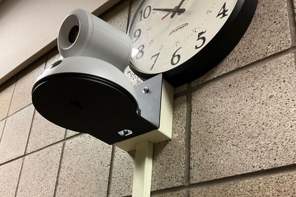 Camera mounted to a wall and instructor enabled adjustments to the lens to allow the instructor to be "seen" by the camera in more locations around the room